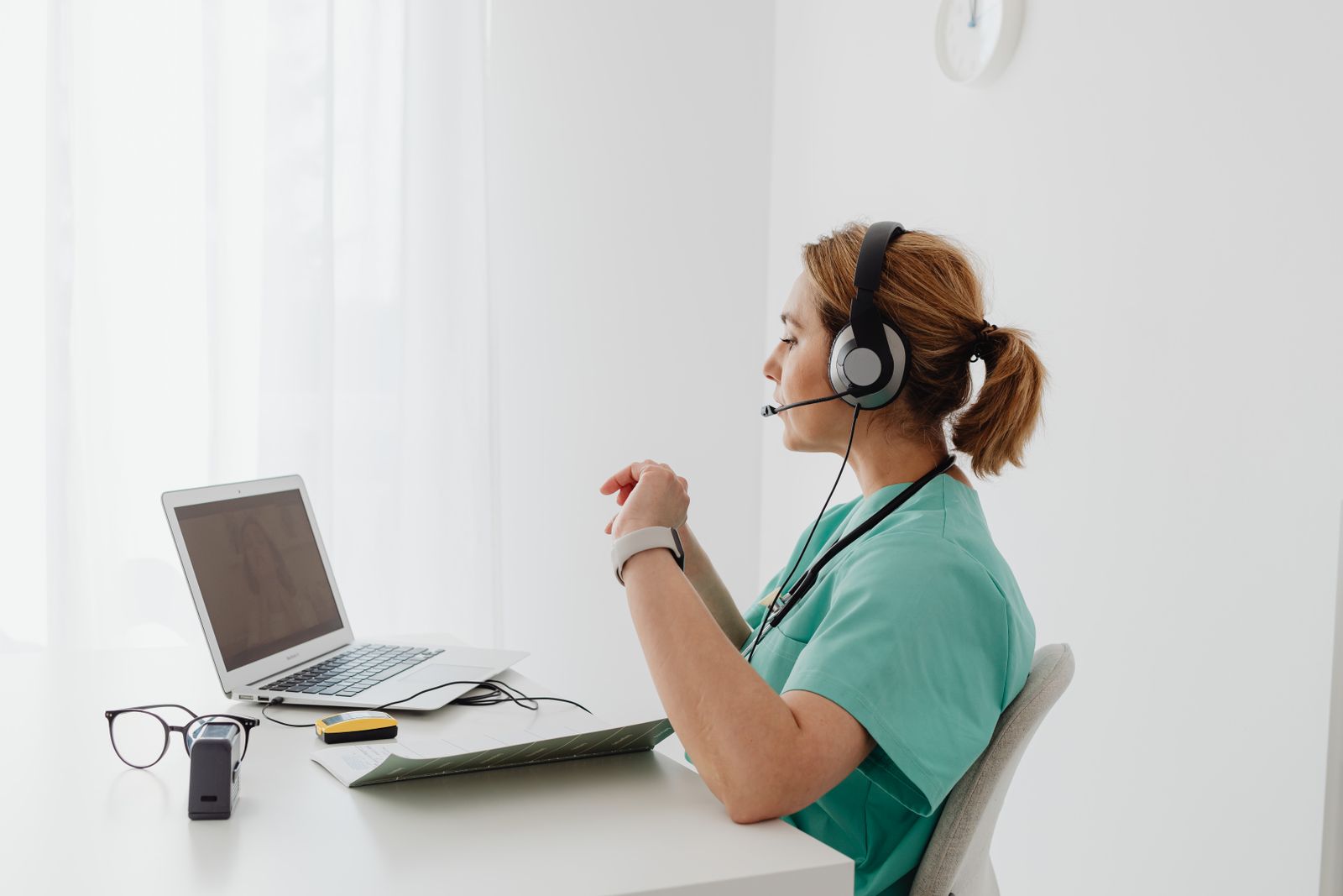A nurse on a telehealth call at her workstation